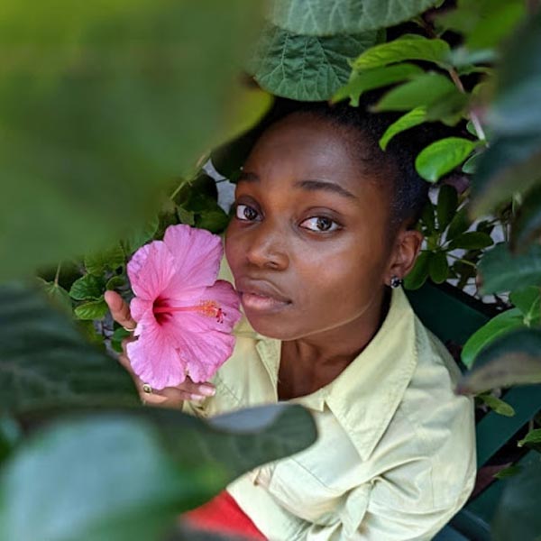 girl looking through leaves