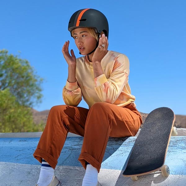 girl sitting beside skateboard
